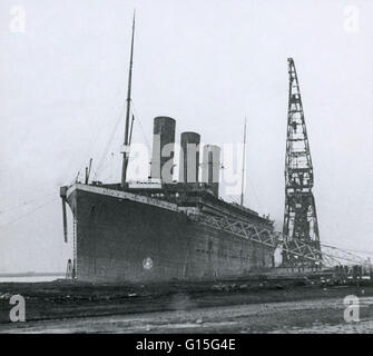 The Titanic during outfitting. Notice there are only three funnels, the fourth was a 'dummy' and not yet added in this photo. The Titanic steamship was the largest ship ever built at the time, measuring 268 meters long and weighing 67,000 tonnes. The Tita Stock Photo