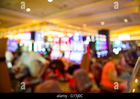 Blurry out of focus players on slot machines in a casino in Las Vegas Stock Photo