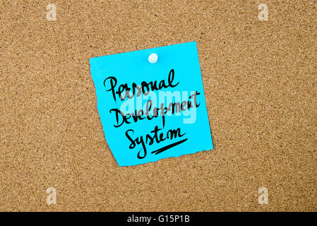 Personal Development System written on blue paper note pinned on cork board with white thumbtacks, copy space available Stock Photo