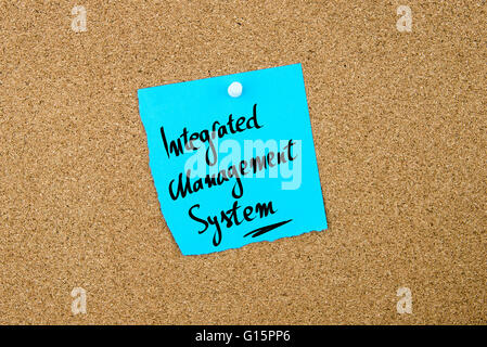 Integrated Management System written on blue paper note pinned on cork board with white thumbtacks, copy space available Stock Photo