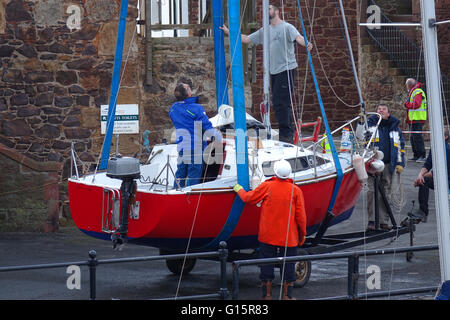 Mobile Crane lifting yacht into harbour, North Berwick Stock Photo