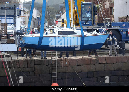 Mobile Crane lifting yacht into harbour, North Berwick Stock Photo