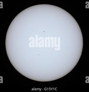 Leeds, UK. 09th May, 2016. Mercury is the closest to the centre of the sun during it's transit in an event which takes place only thirteen times a century. The last time being the 7th May 2006 and the next transit being the 11th November 2019. Mercury is the smallest planet in our solar system and travels at approximately 106,000 mph. The sun spots at the centre of the sun appear larger than the disc of mercury. Taken on the 9th May 2016 in Leeds, West Yorkshire. Credit:  Andrew Gardner/Alamy Live News Stock Photo