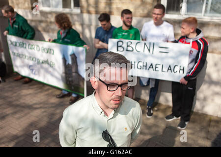 Belfast, UK. 9th May, 2016. Senator Niall Ó Donnghaile being interviewed outside BBC headquarters at Broadcasting House in Northern Ireland. Protesters, in what they described as the BBC cutting them short when a question was raised in regards to the Irish language during a the BBC election debate Credit:  Bonzo/Alamy Live News Stock Photo