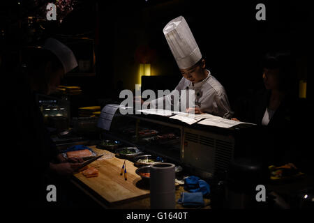 Taiyuan, Taiyuan, CHN. 6th May, 2016. Taiyuan, China - May 6 2016: (EDITORIAL USE ONLY. CHINA OUT ) She is checking the orders. Li Rufang, born in 1993, Taiyuan Shanxi. She learned teppanyaki from her cook brother in Beijing. After years she went back to Taiyuan and worked in Japanese Restaurant of five-star Mandarin Oriental Hotel. © SIPA Asia/ZUMA Wire/Alamy Live News Stock Photo