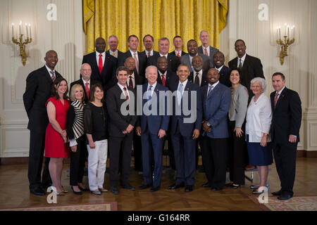 Washington, DC, USA. 09th May, 2016. US President Barack Obama, with Vice President Joseph Biden, greets former players and staff of the 1983 NCAA National Basketball Championship North Carolina State Wolfpack in the East Room of the White House in Washington, DC, USA, 09 May 2016. The President and Vice President met briefly with members of the team and their families in the East Room. The team was previously unable to visit the White House to be recognized for their championship. Credit: Shawn Thew/Pool via CNP - NO WIRE SERVICE - © dpa/Alamy Live News Stock Photo