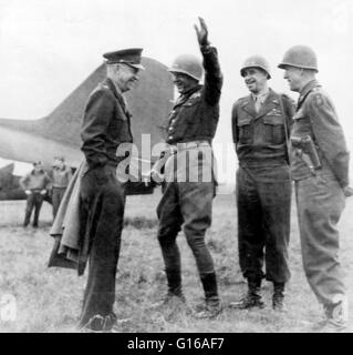 General Eisenhower meeting with generals Patton, Bradley, and Hodges on an airfield somewhere in Germany during impromptu conference with supreme commander, March 25, 1945. Prior to this somewhat lighthearted moment Patton's troops had captured Mainz, Ger Stock Photo