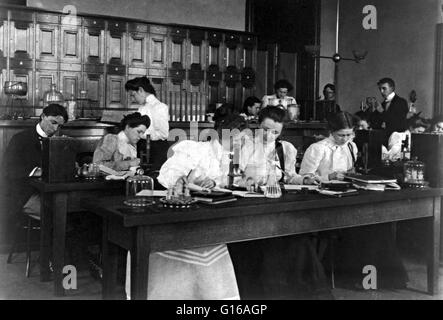 Students in a science class using microscopes, Western High School, Washington, D.C. High school is an institution which provides all or part of secondary education. Photographed by Frances 'Fannie' Benjamin Johnston (January 15, 1864 - May 16, 1952) was Stock Photo