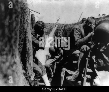 American soldiers in trench putting on gas masks, World War I. The first use of poison gas on the Western Front was on April 22, 1915, by the Germans at Ypres, against Canadian and French colonial troops. The British Royal Society of Chemistry claims that Stock Photo