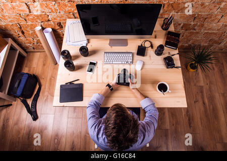 Photographer at the desk, office gadgets and object lens Stock Photo