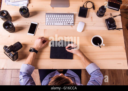 Photographer at the desk, office gadgets and object lens Stock Photo