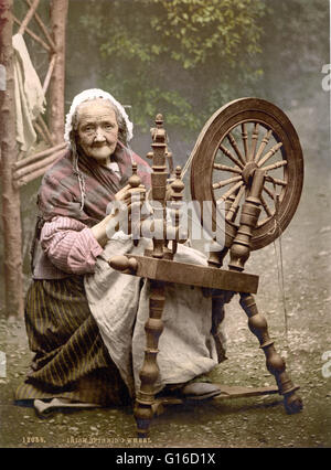 Irish spinner and spinning wheel. County Galway, Ireland photographed by the Detroit Publishing Company circa 1890-1900. A spinning wheel is a device for spinning thread or yarn from natural or synthetic fibers. Spinning wheels appeared in Asia, probably Stock Photo