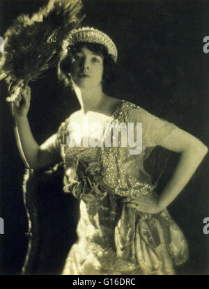 Gertrude Vanderbilt Whitney (Mrs. Harry Payne Whitney) wearing a jeweled gown and tiara and holding a peacock feather fan. During the Victorian Age in the United States Tiaras were being seen on non-royal ladies of means. By the 1920s, the tiara and simil Stock Photo