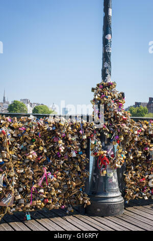 Image of locked padlocks placed on the bridge railings and lamp post of Pont des Arts, Paris, France Stock Photo