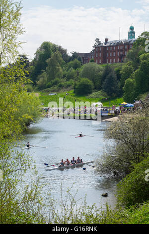 Shrewsbury School looks down on rowers competing in Shrewsbury Regatta on the River Severn, Shropshire, England, UK Stock Photo