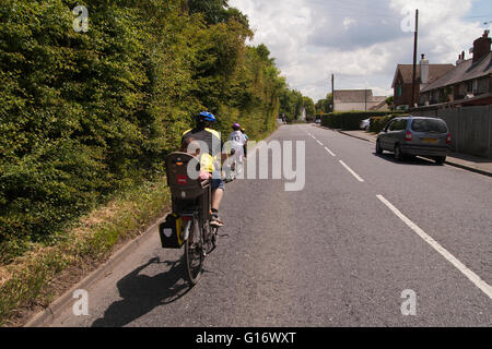 family out cycling in the British countryside in Kent UK Stock Photo