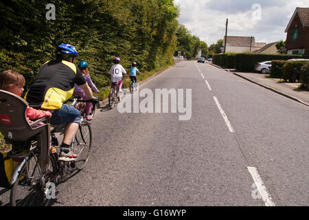 family out cycling in the British countryside in Kent UK Stock Photo