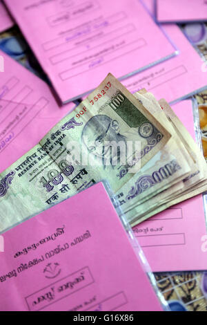 Indian Rupees and saving books of a micro finance loan-self-help group, meeting of a saving and lending community of the Peermade Development Society PDS. Peermade, Kerala, India Stock Photo
