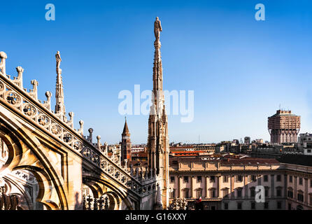 White marble statues on the roof of famous Cathedral Duomo di Milano on piazza in Milan, Italy Stock Photo