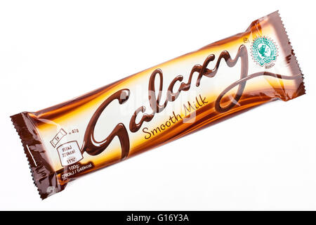 LONDON, UK - MAY 6TH 2016: An unopened Galaxy chocolate bar manufactured by Mars Inc, pictured over a plain white background on Stock Photo