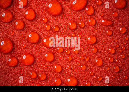 Drops of water on red waterproof fabric Stock Photo