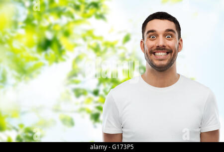 man with funny face over green natural background Stock Photo