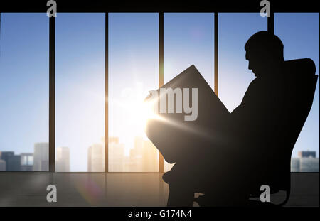 silhouette of businessman reading documents Stock Photo