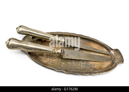 Two antique table knifes on tray isolated on white Stock Photo