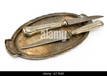 Two antique table knifes on tray isolated on white Stock Photo