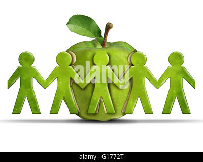 Group health and community health care or healthcare concept as a green apple with cut out peeled fruit skin shaped as humans ho Stock Photo