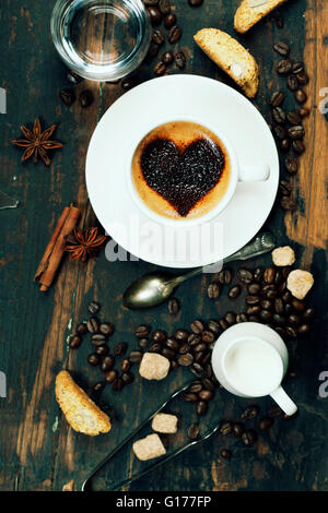 Cup of coffee with heart on foam and some ingredients Stock Photo