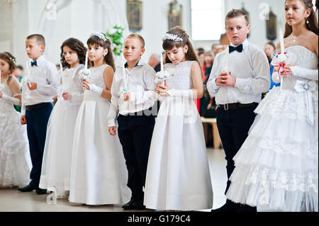 LVIV, UKRAINE - MAY 8, 2016: The ceremony of a First Communion in the Church of St. Peter the Great of Ukrainian Greek Catholic  Stock Photo