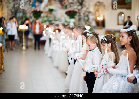 LVIV, UKRAINE - MAY 8, 2016: The ceremony of a First Communion in the Church of St. Peter the Great of Ukrainian Greek Catholic  Stock Photo