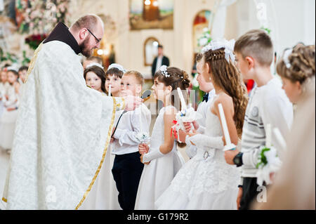 LVIV, UKRAINE - MAY 8, 2016: The ceremony of a First Communion in the Church of St. Peter the Great of Ukrainian Greek Catholic  Stock Photo