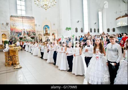 LVIV, UKRAINE - MAY 8, 2016: The ceremony of a First Communion in the Church of St. Peter the Great of Ukrainian Greek Catholic  Stock Photo