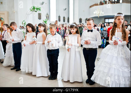 LVIV, UKRAINE - MAY 8, 2016: The ceremony of a First Communion in the Church of St. Peter the Great of Ukrainian Greek Catholic  Stock Photo