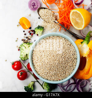 Bowl of healthy white quinoa seeds and fresh organic vegetables - Healthy Eating, Diet, Vegetarian or Cooking concept Stock Photo