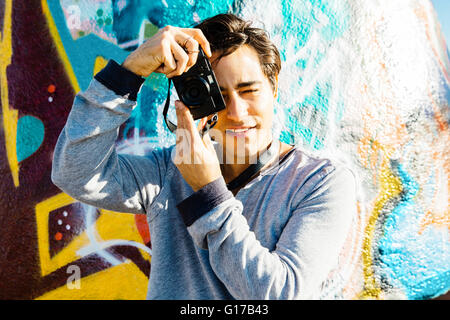 Young man using digital camera Stock Photo
