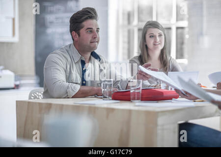 Businessman and businesswoman brainstorming in loft office Stock Photo