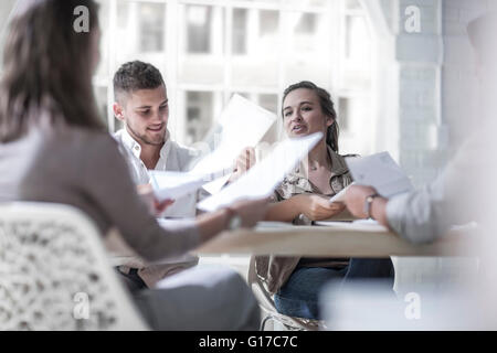 Businessmen and businesswomen brainstorming in loft office Stock Photo