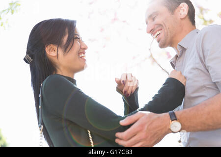 Low angle view of couple face to face smiling Stock Photo