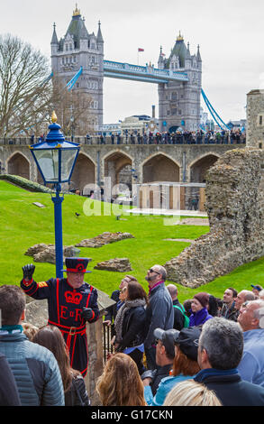 LONDON, UK - APRIL 10TH 2016: A Yeomen Warder talking to visitors during a tour of the historic Tower of London. Stock Photo