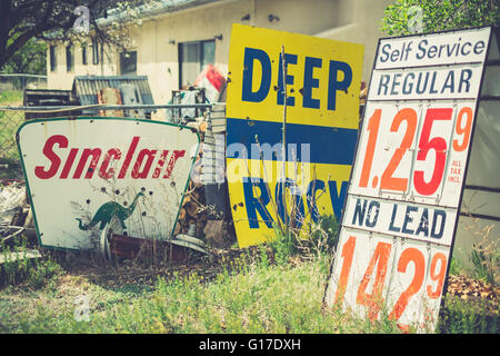 Vintage gas station signs on ground with cheap regular and no lead gas prices at the Classical Gas Museum, Embudo, New Mexico Stock Photo