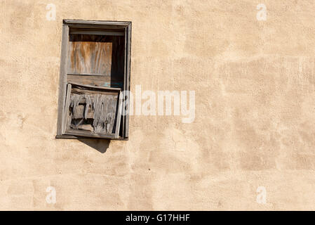 Boarded up window in an abandoned building in the West Texas town of Barstow. Stock Photo