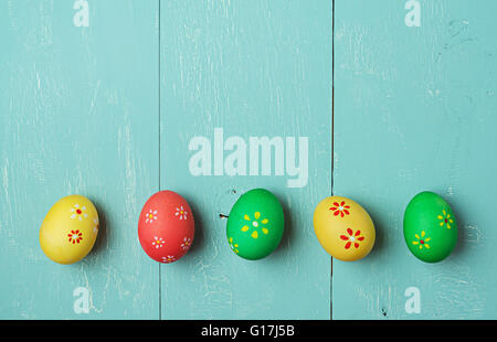 multicolored easter eggs on vintage painted wooden background with craquelure Stock Photo