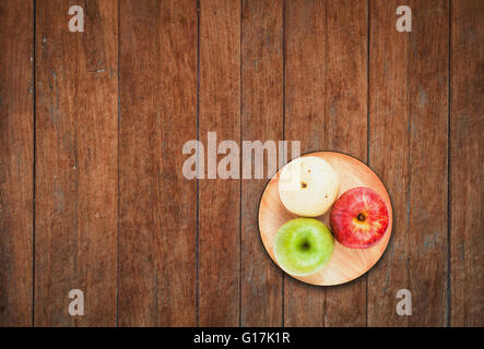 Top view of three different kind of apples on wooden background Stock Photo