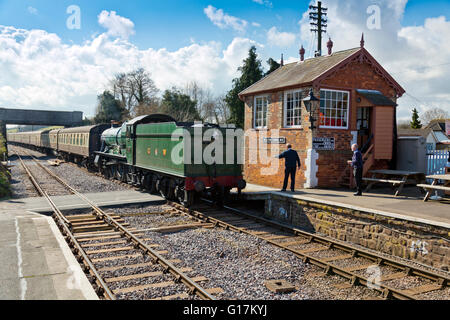 The signalman waits to  exchange the single line token at Williton station on the West Somerset Railway, England, UK Stock Photo