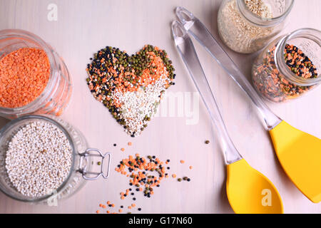 Red, white, and black lentils forming a heart shape Stock Photo