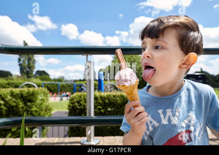 Boy enjoying ice-cream cone near playground, Richmond, London Stock Photo