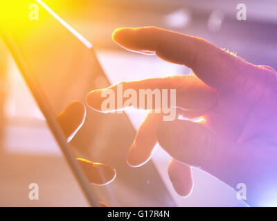 Man using touchscreen device, close-up Stock Photo